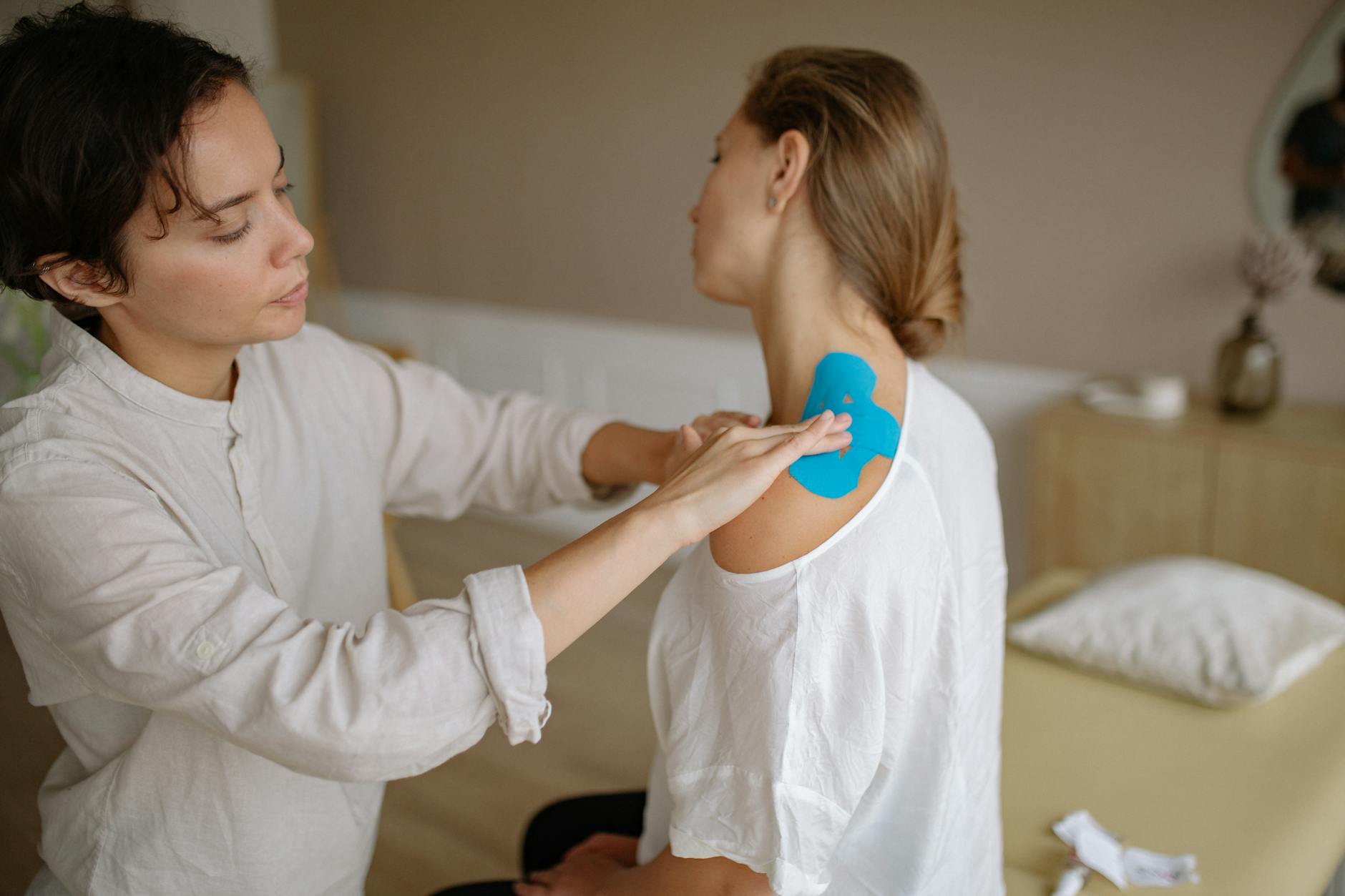 Physical therapist guiding shoulder exercises
