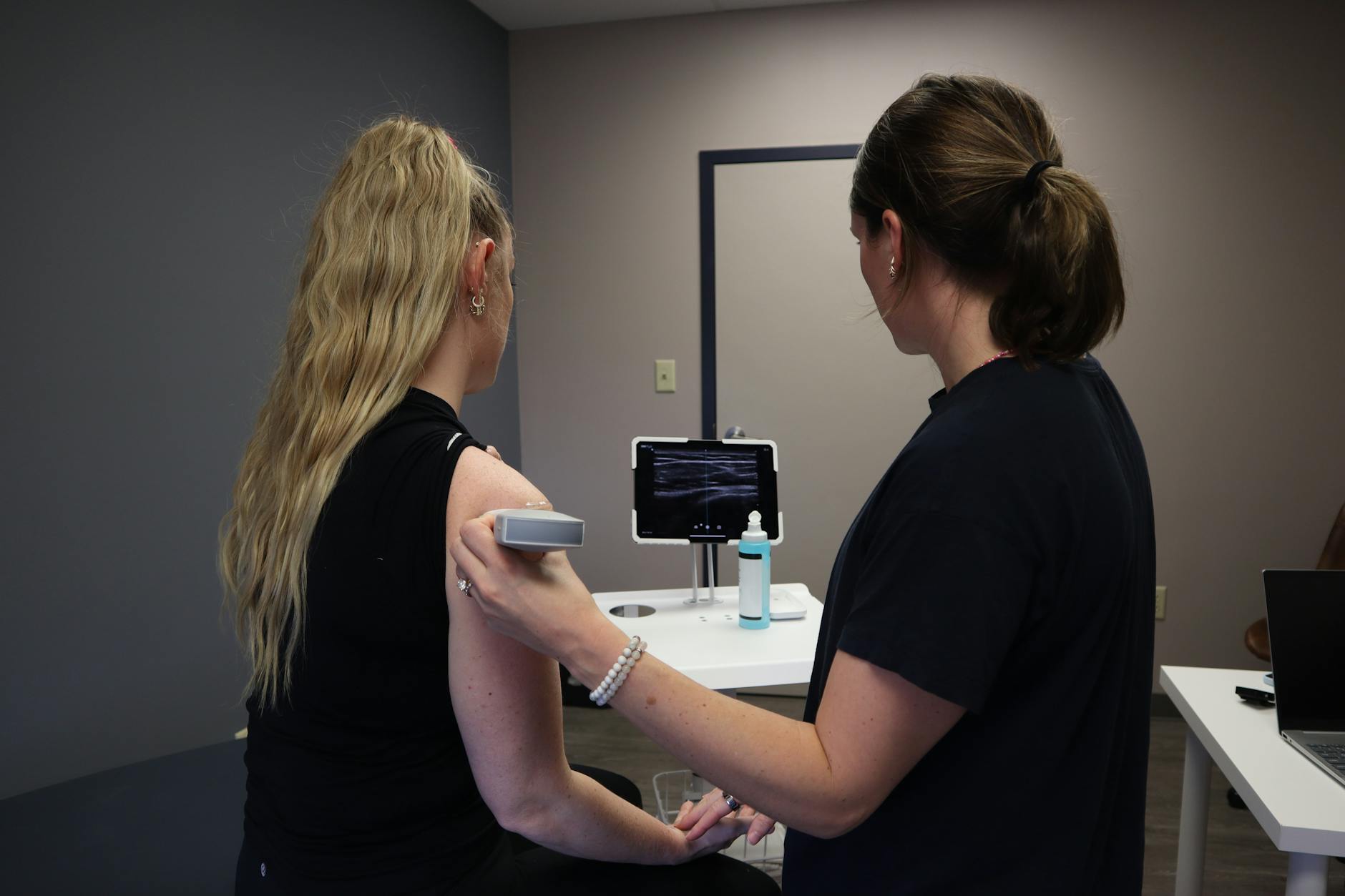 Sports medicine physician examining an athlete